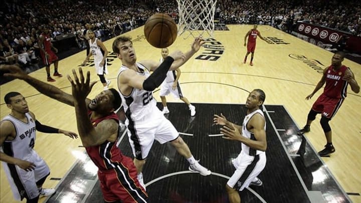 Jun 11, 2013; San Antonio, TX, USA; Miami Heat power forward Udonis Haslem (40) and San Antonio Spurs center Tiago Splitter (22) rebound during the first half of game three of the 2013 NBA Finals at the AT