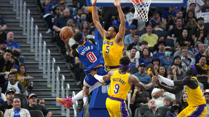 Apr 7, 2022; San Francisco, California, USA; Los Angeles Lakers guard Talen Horton-Tucker (5) defends a shot by Golden State Warriors guard Gary Payton II (0) during the second quarter at Chase Center. Mandatory Credit: Darren Yamashita-USA TODAY Sports