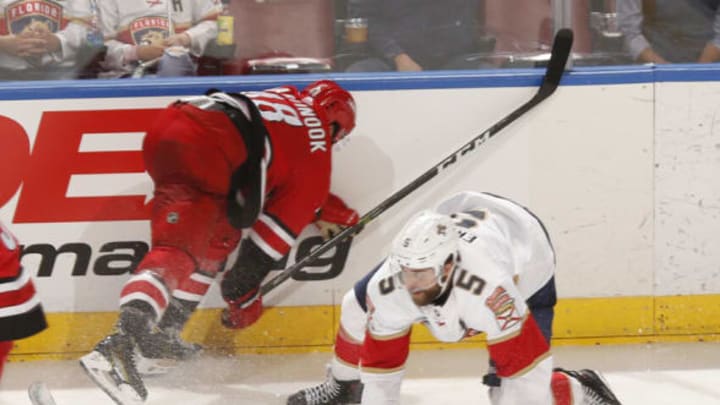 SUNRISE, FL – FEBRUARY 21: Jordan Martinook #48 of the Carolina Hurricanes and Aaron Ekblad #5 of the Florida Panthers collide along with the board during third-period action at the BB&T Center on February 21, 2019, in Sunrise, Florida. The Hurricanes defeated the Panthers 4-3. (Photo by Joel Auerbach/Getty Images)