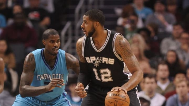 Nov 23, 2016; Charlotte, NC, USA; San Antonio Spurs forward center LaMarcus Aldridge (12) looks to pass the ball as he is defended by Charlotte Hornets forward Marvin Williams (2) during the first half of the game at the Spectrum Center. Mandatory Credit: Sam Sharpe-USA TODAY Sports