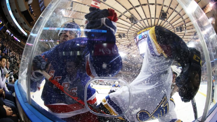 NEW YORK, NEW YORK – MARCH 03: Greg McKegg #14 of the New York Rangers and Vince Dunn #29 of the St. Louis Blues crash the boards during their game at Madison Square Garden on March 03, 2020 in New York City. (Photo by Al Bello/Getty Images)