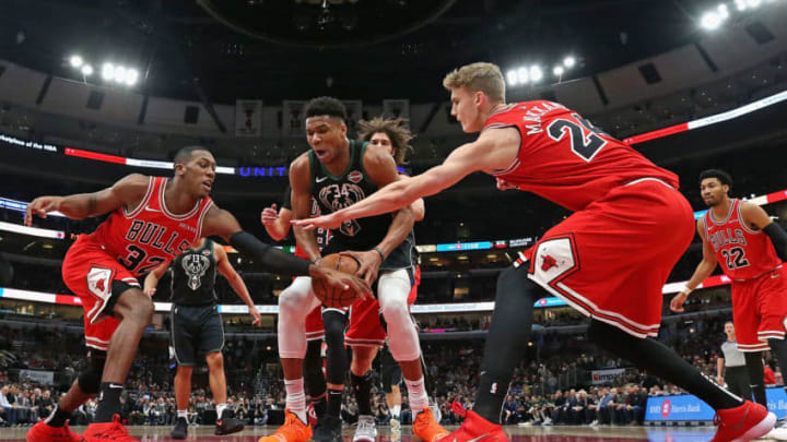 CHICAGO, ILLINOIS - FEBRUARY 11: Giannis Antetokounmpo #34 of the Milwaukee Bucks is pressured by Kris Dunn #32 (L) and Lauri Markkanen #24 of the Chicago Bulls at the United Center on February 11, 2019 in Chicago, Illinois. The Bucks defeated the Bulls 112-99. NOTE TO USER: User expressly acknowledges and agrees that, by downloading and or using this photograph, User is consenting to the terms and conditions of the Getty Images License Agreement. (Photo by Jonathan Daniel/Getty Images)