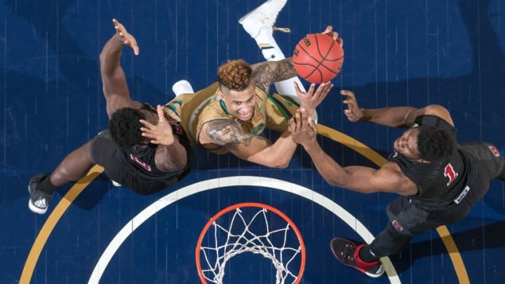 Mar 5, 2016; South Bend, IN, USA; Notre Dame Fighting Irish forward Zach Auguste (30) goes up for a shot as North Carolina State Wolfpack forward Abdul-Malik Abu (0) and forward Lennard Freeman (1) defend in the second half at the Purcell Pavilion. Notre Dame won 89-75. Mandatory Credit: Matt Cashore-USA TODAY Sports