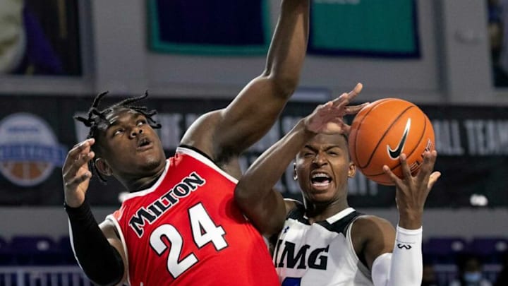 L.T. Overton of Milton tries to stop a shot by Jaden Bradley of IMG in the Geico High School Nationals tournament on Thursday, April 1, 2021, at Suncoast Credit Union Arena in Fort Myers.Fnp 040121 Ai Miltonimg 002