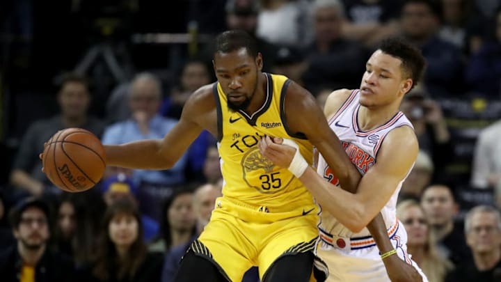 OAKLAND, CALIFORNIA - JANUARY 08: Kevin Durant #35 of the Golden State Warriors is guarded by Kevin Knox #20 of the New York Knicks at ORACLE Arena on January 08, 2019 in Oakland, California. NOTE TO USER: User expressly acknowledges and agrees that, by downloading and or using this photograph, User is consenting to the terms and conditions of the Getty Images License Agreement. (Photo by Ezra Shaw/Getty Images)