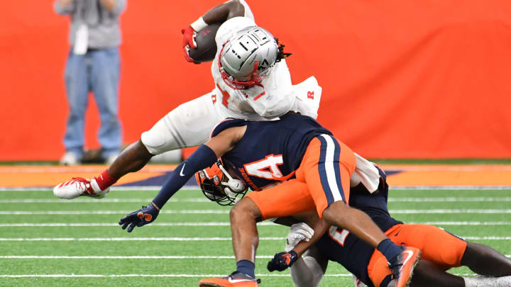 Sep 11, 2021; Syracuse, New York, USA; Rutgers Scarlet Knights running back Isaih Pacheco (1) is tackled by Syracuse Orange defensive back Jason Simmons (14) in the fourth quarter at the Carrier Dome. Mandatory Credit: Mark Konezny-USA TODAY Sports