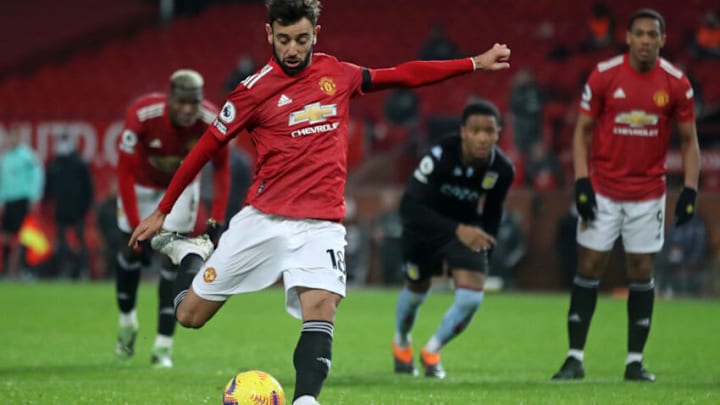 Manchester United's Portuguese midfielder Bruno Fernandes scores their second goal from the penalty spot during the English Premier League football match between Manchester United and Aston Villa at Old Trafford in Manchester, north west England, on January 1, 2021. (Photo by CARL RECINE / POOL / AFP) / RESTRICTED TO EDITORIAL USE. No use with unauthorized audio, video, data, fixture lists, club/league logos or 'live' services. Online in-match use limited to 120 images. An additional 40 images may be used in extra time. No video emulation. Social media in-match use limited to 120 images. An additional 40 images may be used in extra time. No use in betting publications, games or single club/league/player publications. / (Photo by CARL RECINE/POOL/AFP via Getty Images)