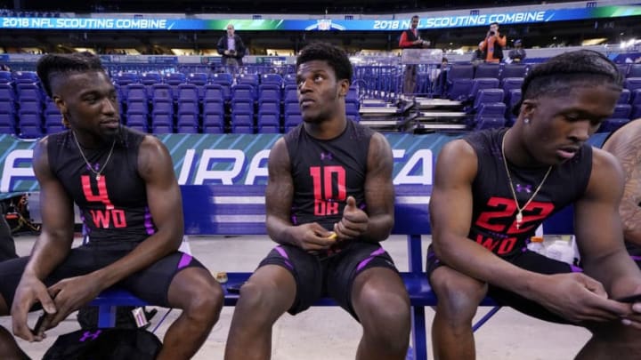 INDIANAPOLIS, IN - MARCH 03: Louisville quarterback Lamar Jackson looks on while talking to Clemson wide receivers Deon Cain (left) and Ray-Ray McCloud (right) during the NFL Combine at Lucas Oil Stadium on March 3, 2018 in Indianapolis, Indiana. (Photo by Joe Robbins/Getty Images)