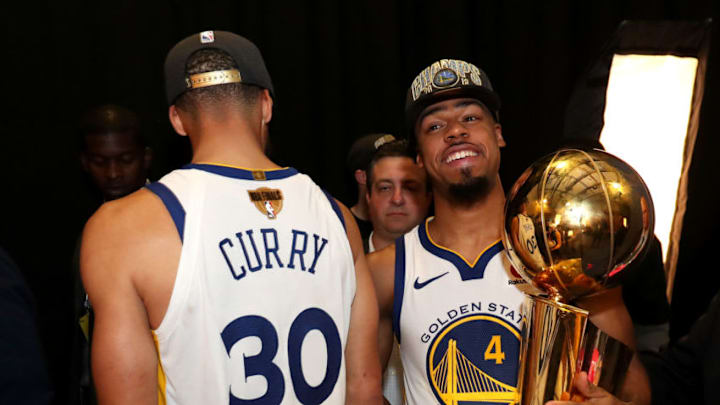 CLEVELAND,OH - Quinn Cook #4 of the Golden State Warriors holds the Larry O'Brien Championship trophy after defeating the Cleveland Cavaliers n Game Four of the 2018 NBA Finals on June 8, 2018 at Quicken Loans Arena in Cleveland, Ohio. NOTE TO USER: User expressly acknowledges and agrees that, by downloading and/or using this photograph, user is consenting to the terms and conditions of the Getty Images License Agreement. Mandatory Copyright Notice: Copyright 2018 NBAE (Photo by Joe Murphy/NBAE via Getty Images)
