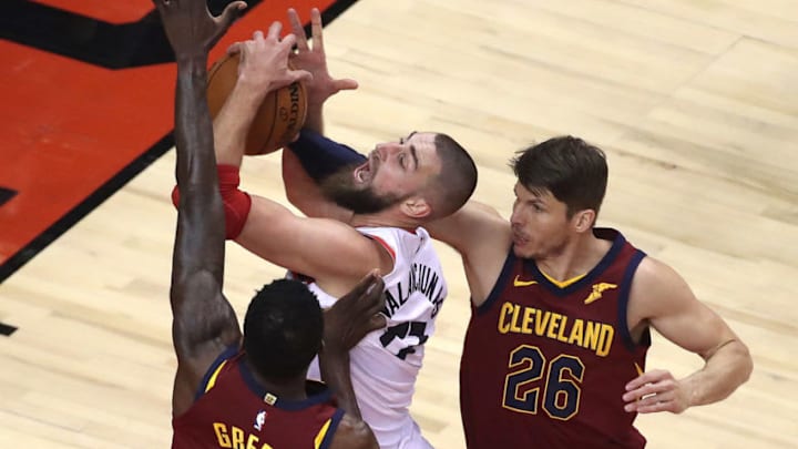 TORONTO, ON- MAY 1 - Cleveland Cavaliers guard Kyle Korver (26) fouls Toronto Raptors center Jonas Valanciunas (17) as the Toronto Raptors play the Cleveland Cavaliers in game 1 of the second round of the NBA playoffs in Toronto. May 1, 2018. (Steve Russell/Toronto Star via Getty Images)