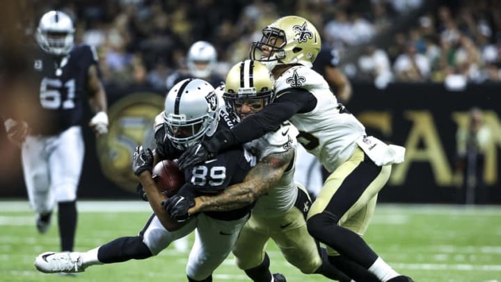 Sep 11, 2016; New Orleans, LA, USA; Oakland Raiders wide receiver Amari Cooper (89) is tackled by New Orleans Saints linebacker James Laurinaitis (53) and cornerback P.J. Williams (25) during the second quarter of a game at the Mercedes-Benz Superdome. Mandatory Credit: Derick E. Hingle-USA TODAY Sports