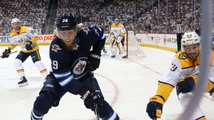 WINNIPEG, MB - MAY 1: Patrik Laine #29 of the Winnipeg Jets and Roman Josi #59 of the Nashville Predators battle for the puck along the corner boards during first period action in Game Three of the Western Conference Second Round during the 2018 NHL Stanley Cup Playoffs at the Bell MTS Place on May 1, 2018 in Winnipeg, Manitoba, Canada. (Photo by Jonathan Kozub/NHLI via Getty Images)