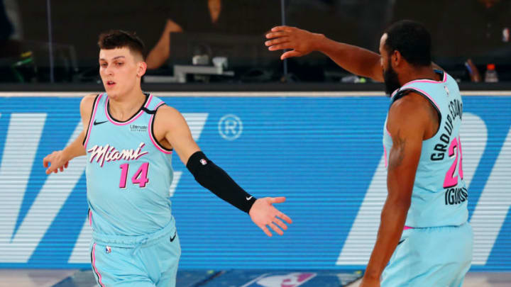 Tyler Herro #14 of the Miami Heat celebrates with Andre Iguodala #28 after scoring a three point basket during the second half against the Indiana Pacers (Photo by Kim Klement - Pool/Getty Images)