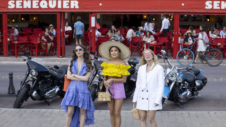 Emily in Paris. (L to R) Lily Collins as Emily, Ashley Park as Mindy, Camille Razat as Camille in episode 202 of Emily in Paris. Cr. Carole Bethuel/Netflix © 2021