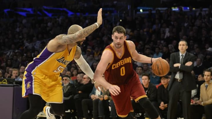 Jan 15, 2015; Los Angeles, CA, USA; Cleveland Cavaliers forward Kevin Love (0) drives to the basket against Los Angeles Lakers forward Carlos Boozer (5) in the first half during the NBA game at Staples Center. Mandatory Credit: Richard Mackson-USA TODAY Sports