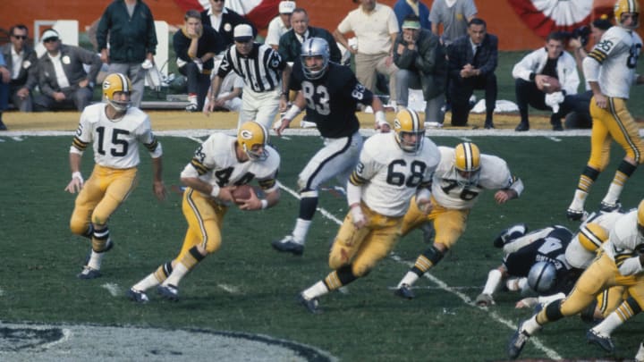 MIAMI – JANUARY 14: Quarterback Bart Starr #15 of the Green Bay Packers hands the ball off to Donny Anderson #44 against the Oakland Raiders defense during Super Bowl II in Miami, Florida on January 14, 1968. The Packers defeated the Raiders 33-14. (Photo by Focus On Sport/Getty Images)