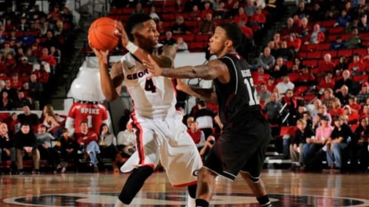 Feb 8, 2014; Athens, GA, USA; Georgia Bulldogs guard Charles Mann (4) protects the ball from Texas A&M Aggies guard Fabyon Harris (12) during the second half at Stegeman Coliseum. Georgia defeated Texas A&M 62-50. Mandatory Credit: Dale Zanine-USA TODAY Sports