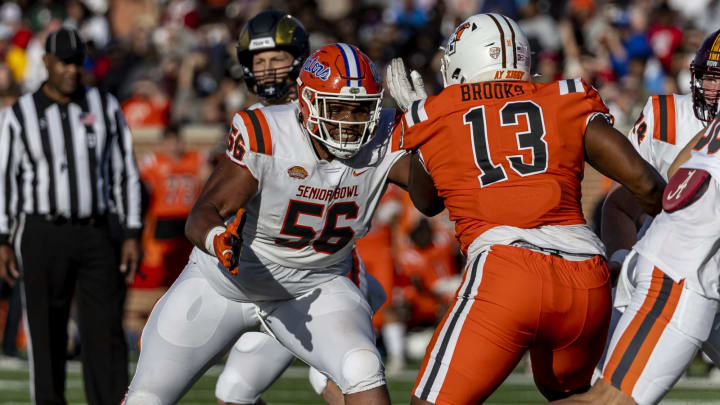 Feb 4, 2023; Mobile, AL, USA; American offensive lineman O’Cyrus Torrence of Florida (56) looks to block National defensive lineman Karl Brooks of Bowling Green (13) during the second half of the Senior Bowl college football game at Hancock Whitney Stadium. Mandatory Credit: Vasha Hunt-USA TODAY Sports