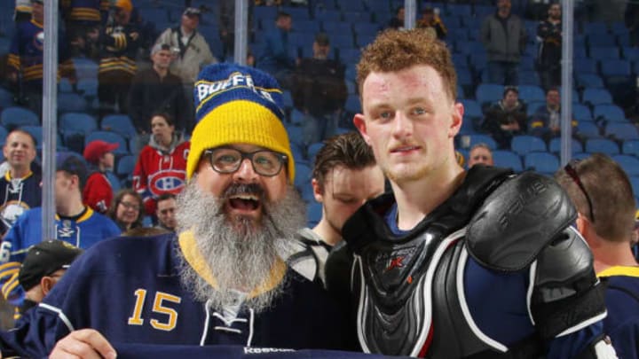BUFFALO, NY – APRIL 05: Jack Eichel of the Buffalo Sabres, right, gives his jersey to a fan after their NHL game against the Montreal Canadiens at KeyBank Center on April 5, 2017 in Buffalo, New York. (Photo by Bill Wippert/NHLI via Getty Images)