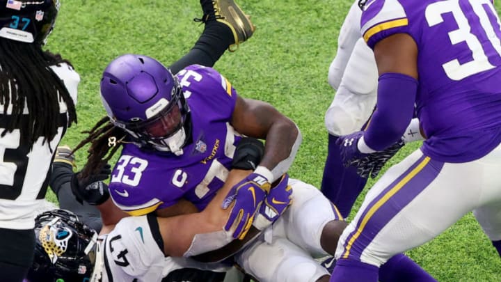 MINNEAPOLIS, MINNESOTA – DECEMBER 06: Dalvin Cook #33 of the Minnesota Vikings gets the first down on the 1-yard line as Joe Schobert #47 of the Jacksonville Jaguars defends in the second half at U.S. Bank Stadium on December 06, 2020, in Minneapolis, Minnesota. (Photo by Adam Bettcher/Getty Images)