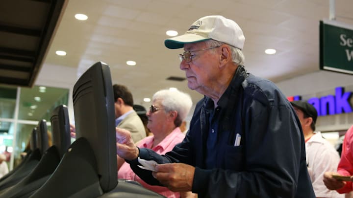 May 01, 2015: This racing fan places a bet at an automated wager machine before the 141st running of the Kentucky Oaks at Churchill Downs in Louisville, Ky. (Photo by Jeff Moreland/Icon Sportswire/Corbis via Getty Images)