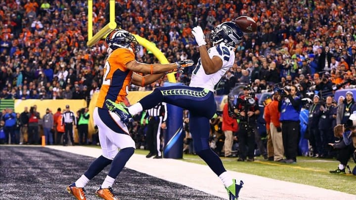 Feb 2, 2014; East Rutherford, NJ, USA; Denver Broncos cornerback Tony Carter (32) is called for pass interference against Seattle Seahawks wide receiver Golden Tate (81) in the end zone during the second quarter in Super Bowl XLVIII at MetLife Stadium. Mandatory Credit: Mark J. Rebilas-USA TODAY Sports