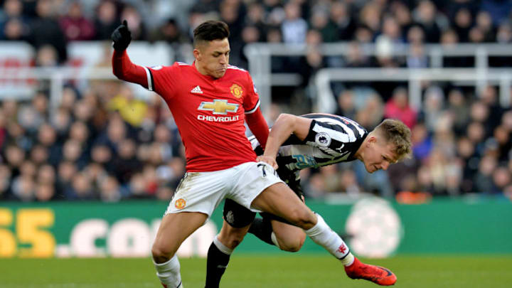 NEWCASTLE UPON TYNE, ENGLAND - FEBRUARY 11: Alexis Sanchez of Manchester United is challenged by Matt Ritchie of Newcastle United during the Premier League match between Newcastle United and Manchester United at St. James Park on February 11, 2018 in Newcastle upon Tyne, England. (Photo by Mark Runnacles/Getty Images)