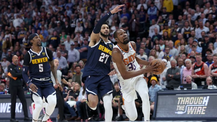 DENVER, COLORADO – MAY 01: Kevin Durant of the Phoenix Suns drives against Jamal Murray of the Denver Nuggets. (Photo by Matthew Stockman/Getty Images)