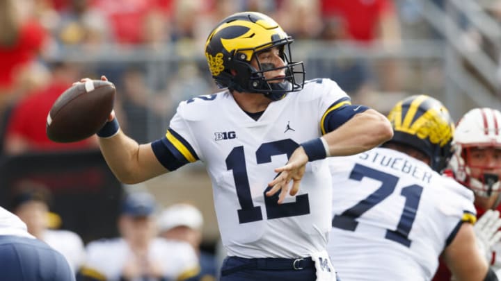 Oct 2, 2021; Madison, Wisconsin, USA; Michigan Wolverines quarterback Cade McNamara (12) throws a pass during the first quarter against the Wisconsin Badgers at Camp Randall Stadium. Mandatory Credit: Jeff Hanisch-USA TODAY Sports