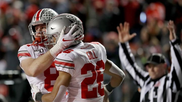 PISCATAWAY, NEW JERSEY - NOVEMBER 16: Jake Hausmann #81 of the Ohio State Buckeyes celebrates his touchdown with teammate Jaelen Gill #26 in the third quarter against the Rutgers Scarlet Knights at SHI Stadium on November 16, 2019 in Piscataway, New Jersey.The Ohio State Buckeyes defeated the Rutgers Scarlet Knights 56-21. (Photo by Elsa/Getty Images)