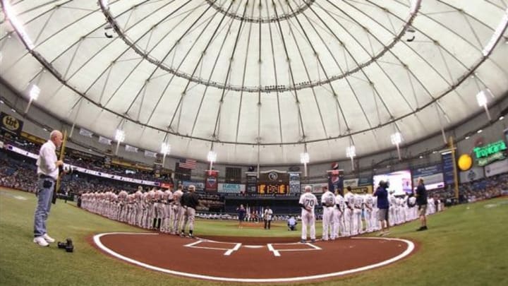 April 2, 2012; St. Petersburg, FL, USA; The Baltimore Orioles and Tampa Bay Rays line up on during the national anthem on opening day at Tropicana Field. Mandatory Credit: Kim Klement-USA TODAY Sports