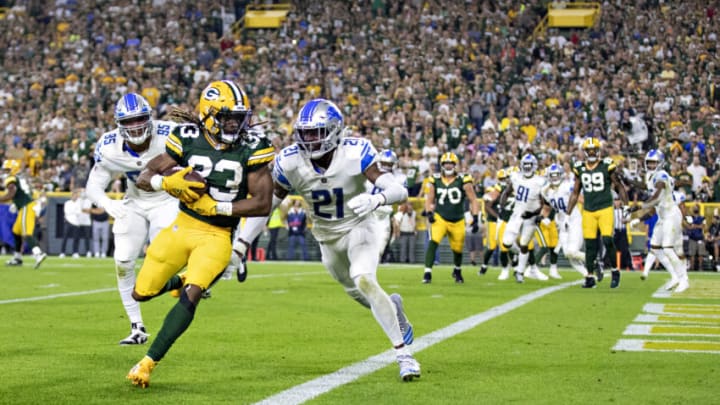 GREEN BAY, WI – SEPTEMBER 20: Aaron Jones #33 of the Green Bay Packers runs a pass in for a touchdown during a game against the Detroit Lions at Lambeau Field on September 20, 2021 in Green Bay, Wisconsin. The Packers defeated the Lions 35-17. (Photo by Wesley Hitt/Getty Images)