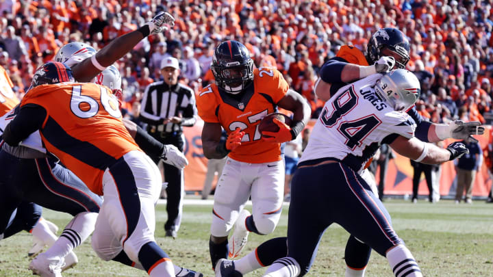 Jan 19, 2014; Denver, CO, USA; Denver Broncos running back Knowshon Moreno (27) rushes the ball during the first half against the New England Patriots during the 2013 AFC championship playoff football game at Sports Authority Field at Mile High. Mandatory Credit: Matthew Emmons-USA TODAY Sports