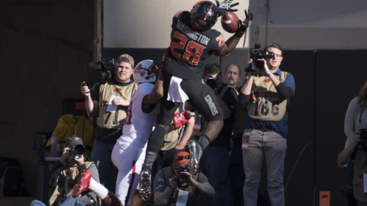 STILLWATER, OK - NOVEMBER 12: Wide receiver James Washington #28 of the Oklahoma State Cowboys is unable to catch a pass as defensive back Justis Nelson #31 of the Texas Tech Red Raiders applies pressure during the first half of a NCAA football game November 12, 2016 at Pickens Stadium in Stillwater, Oklahoma. (Photo by J Pat Carter/Getty Images)