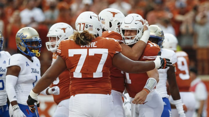 AUSTIN, TX – SEPTEMBER 08: Sam Ehlinger #11 of the Texas Longhorns is congratulated by Patrick Vahe #77 and Elijah Rodriguez #72 after a touchdown in the first quarter against the Tulsa Golden Hurricane at Darrell K Royal-Texas Memorial Stadium on September 8, 2018 in Austin, Texas. (Photo by Tim Warner/Getty Images)