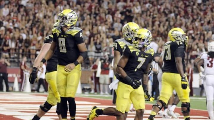Sep 20, 2014; Pullman, WA, USA; Oregon Ducks quarterback Marcus Mariota (8) and wide receiver Keanon Lowe (7) celebrate a touchdown against the Washington State Cougars during the second half at Martin Stadium. The Ducks beat Cougars 38-31. Mandatory Credit: James Snook-USA TODAY Sports
