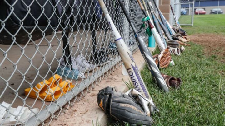 Bats and gloves are lined up at the dugout during Marian University Knights softball team practice at the schools softball field on Thursday, May 9, 2019. The team has gone 49-0 this season.002 Finals