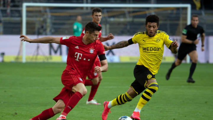 DORTMUND, GERMANY - MAY 26: Robert Lewandowski of Bayern Munich takes on Jadon Sancho of Borussia Dortmund during the Bundesliga match between Borussia Dortmund and FC Bayern Muenchen at Signal Iduna Park on May 26, 2020 in Dortmund, Germany. (Photo by Federico Gambarini/Pool via Getty Images)