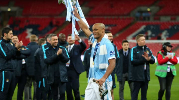 LONDON, ENGLAND – FEBRUARY 28 : Vincent Kompany of Manchester City celebrates with the Capital One cup trophy after the Capital One Cup Final match between Liverpool and Manchester City at Wembley Stadium on February 28, 2016 in London, England. (Photo by Catherine Ivill – AMA/Getty Images)
