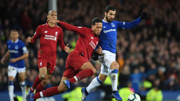 LIVERPOOL, ENGLAND - MARCH 03: Andre Gomes of Everton and Virgil van Dijk of Liverpool battle for the ball during the Premier League match between Everton FC and Liverpool FC at Goodison Park on March 03, 2019 in Liverpool, United Kingdom. (Photo by Shaun Botterill/Getty Images)