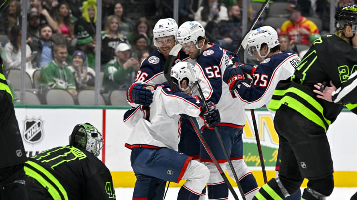 Feb 18, 2023; Dallas, Texas, USA; Columbus Blue Jackets center Jack Roslovic (96) and right wing Emil Bemstrom (52) and defenseman Tim Berni (75) help up center Liam Foudy (19) after he scores a goal against Dallas Stars goaltender Scott Wedgewood (41) during the first period at the American Airlines Center. Mandatory Credit: Jerome Miron-USA TODAY Sports