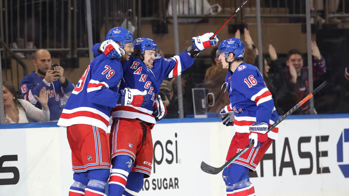 NEW YORK, NEW YORK – DECEMBER 04: Artemi Panarin #10 of the New York Rangers celebrates his goal with teammates K’Andre Miller #79 and Ryan Strome #16 in the third period against the Chicago Blackhawksat Madison Square Garden on December 04, 2021 in New York City. The New York Rangers defeated the Chicago Blackhawks 3-2. (Photo by Elsa/Getty Images)