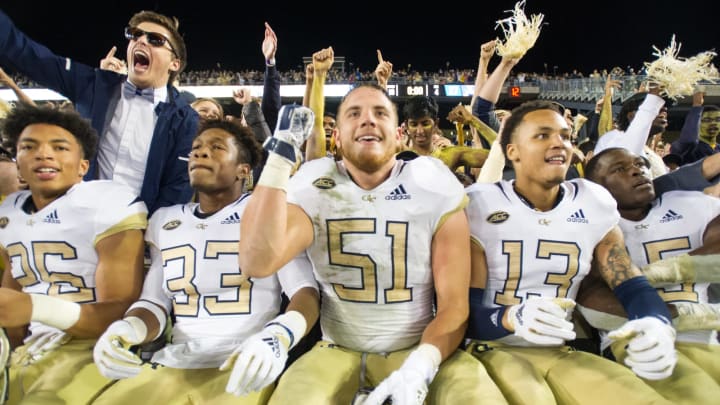 ATLANTA, GA – NOVEMBER 17: Running back Dontae Smith #26, defensive back Jaytlin Askew #33, Brant Mitchell #51 and defensive back Avery Showell #13 of the Georgia Tech Yellow Jackets celebrate after defeating the Virginia Cavaliers at Bobby Dodd Stadium on November 17, 2018 in Atlanta, Georgia. (Photo by Michael Chang/Getty Images)
