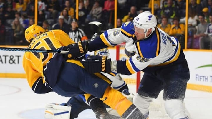 Nov 10, 2016; Nashville, TN, USA; St. Louis Blues defenseman Jay Bouwmeester (19) hits Nashville Predators left wing Austin Watson (51) as he attempts a shot during the third period at Bridgestone Arena. Mandatory Credit: Christopher Hanewinckel-USA TODAY Sports