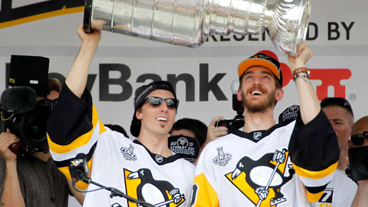 Jun 14, 2017; Pittsburgh, PA, USA; Pittsburgh Penguins goalies Marc-Andre Fleury (29) and Matt Murray (30) lift the Stanley Cup during the Stanley Cup championship parade and rally in downtown Pittsburgh. Mandatory Credit: Charles LeClaire-USA TODAY Sports