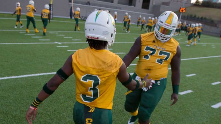 Carver’s Juwon Gaston (3) and Carver’s James Robinson (77) shake hands during warm ups at Cramton Bowl in Montgomery, Ala., on Thursday, Sept. 26, 2019. Lee leads Carver 28-7 at halftime.Jc Fbcarverlee25