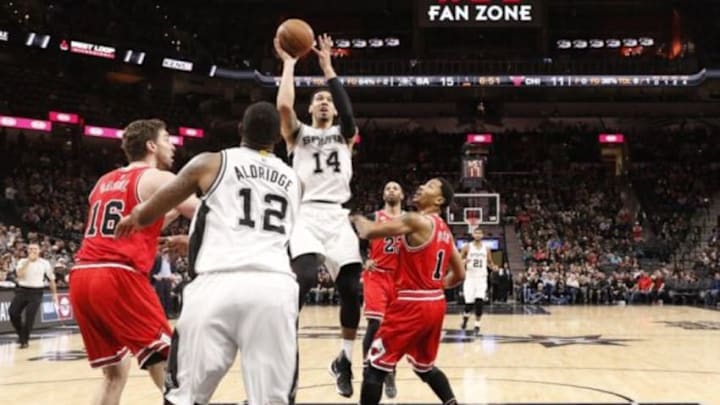Mar 10, 2016; San Antonio, TX, USA; San Antonio Spurs shooting guard Danny Green (14) shoots the ball as Chicago Bulls point guard Derrick Rose (1) defends during the first half at AT&T Center. Mandatory Credit: Soobum Im-USA TODAY Sports