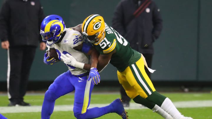Jan 16, 2021; Green Bay, Wisconsin, USA; Green Bay Packers linebacker Krys Barnes (51) tackles Los Angeles Rams running back Cam Akers (23) during the NFC Divisional Round at Lambeau Field. Mandatory Credit: Mark J. Rebilas-USA TODAY Sports