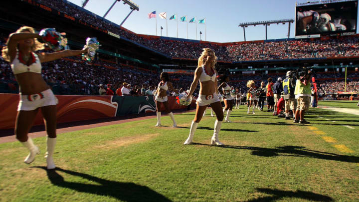 MIAMI - NOVEMBER 16: Cheerleaders work the crowd as the Miami Dolphins play against the Oakland Raiders at Dolphin Stadium November 16, 2008 in Miami, Florida. Miami defeated Oakland 17-15. (Photo by Marc Serota/Getty Images)