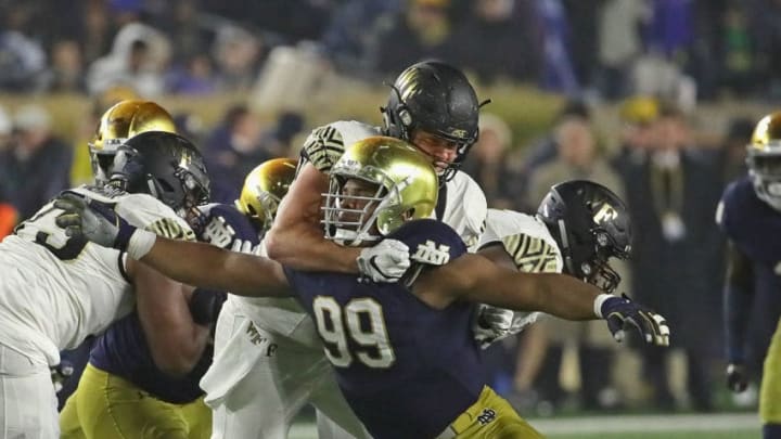 SOUTH BEND, IN - NOVEMBER 04: Jerry Tillery #99 of the Notre Dame Fighting Irish rushes against Ryan Anderson #70 of the Wake Forest Demon Deacons